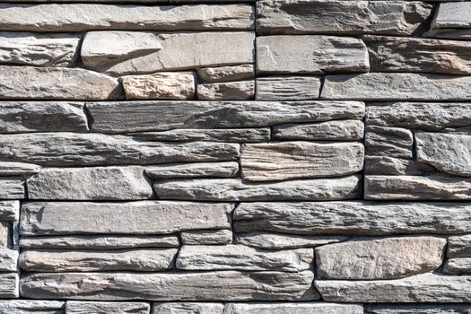 Background from a wall made of old natural gray stone