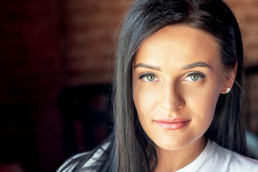 Portrait of beautiful young woman looking at camera. Portrait of brunette business woman.