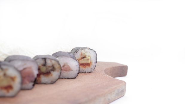 sushi rolls and chopsticks on a wooden table.Japanese cuisine