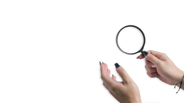 Woman hand holding a magnifying glass isolated on white background. Detective and search concept.