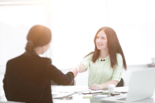 welcome handshake of two business women at the Desk.photo with copy space.