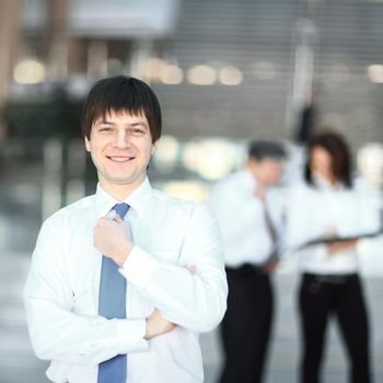 successful young employee on blurred background office.photo with copy space