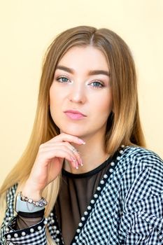 Portrait of a casual business woman sitting at her workplace in home office.