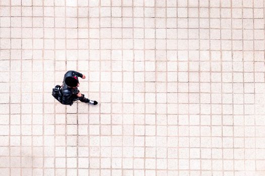 top view of an unrecognizable young man walking around the city, concept of urban lifestyle