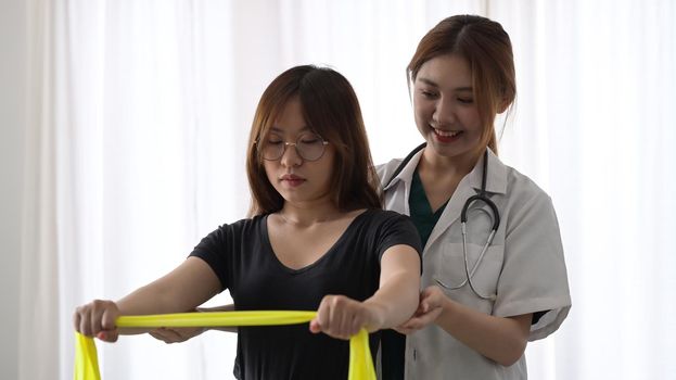 Patient doing some special exercises under supervision of physiotherapist.