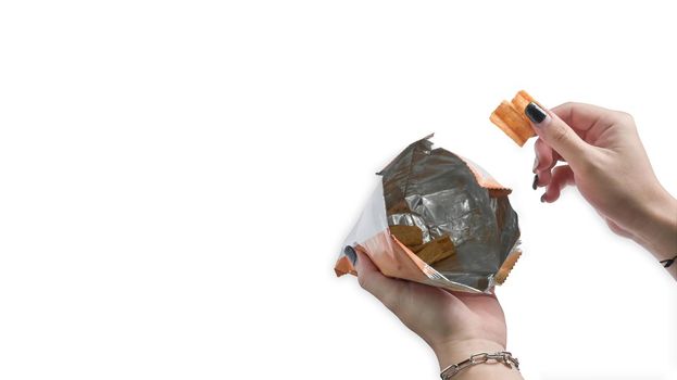 Woman hand holding potato chips with snack bag isolated on white background.