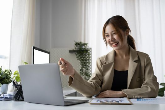 Smiling female employee working in modern office.