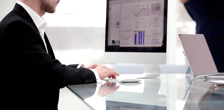 close up.young businessman working with financial charts.photo with copy space