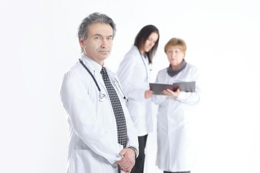 serious therapist doctor on blurred background of colleagues.