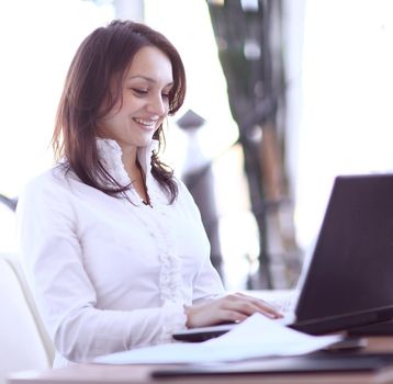 modern business woman working with documents sitting at her Desk in the office