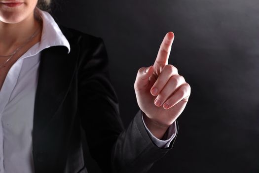 close up.business woman showing index finger up.isolated on black background.