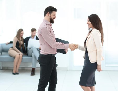 in full growth.Business partners shaking hands in meeting hall