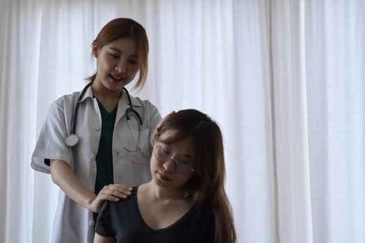 Physiotherapist examining female patient with neck injuries in clinic. Physical therapy concept.