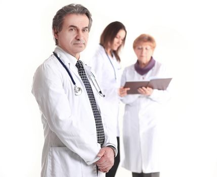 serious therapist doctor on blurred background of colleagues.