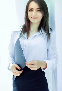 portrait of a serious young business woman on the background of the office.