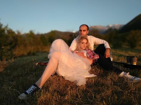 Two lovers on a romantic trip see off the sunset on the outdoor