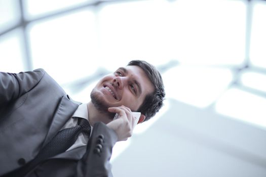 close up.smiling businessman talking on mobile phone.
