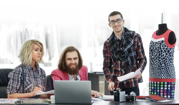 group of designers discussing new ideas in a modern Studio.