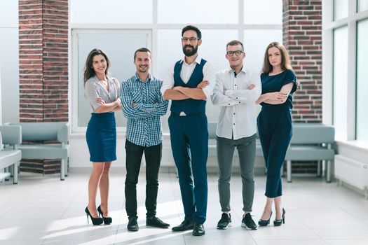 in full growth.professional business team standing in spacious office
