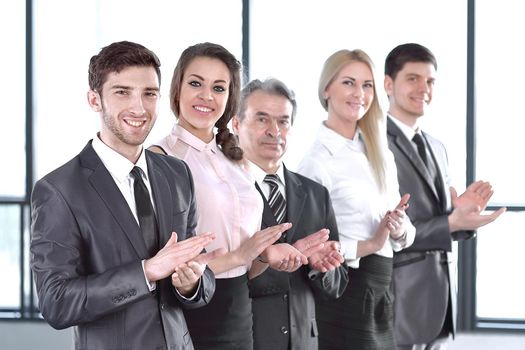 Successful business team applauding at the office. success concept
