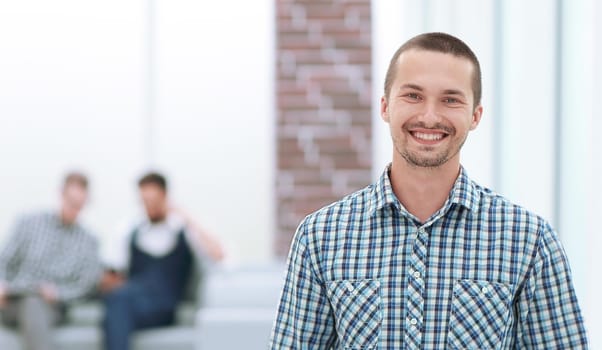 smiling man with a digital tablet standing in the office. people and technology