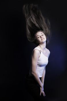 confident young woman with long hair .isolated on a black background. photo with copy space