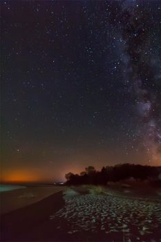 night sky with stars and milky way over beach