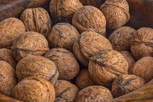 Lots of walnuts in wooden bowl. Close