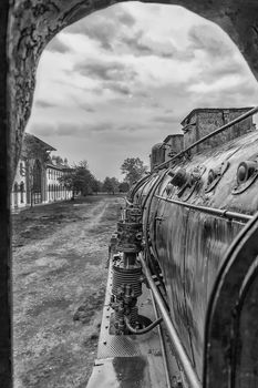 Old steam locomotive window with a view of outside. Black and white