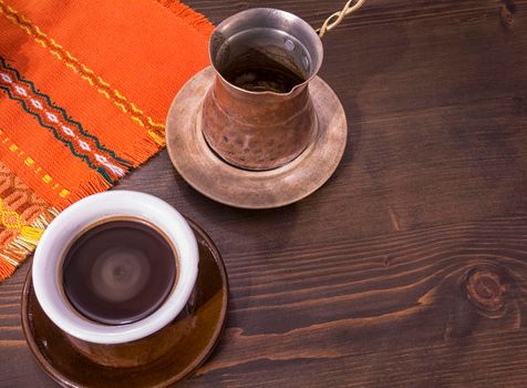 Coffee. Turkish coffee being made in a traditional way. Armenian Turkish coffee. The copper coffee pot and cup of coffee on the table. Traditional serving coffee