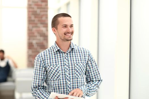 modern man standing near the office window .photo with copy space