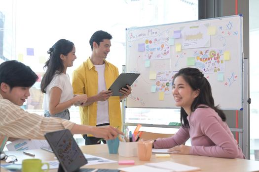 Group of creative people brainstorm over business project together.