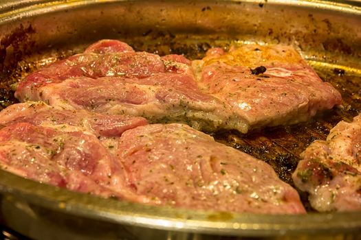 making roasting fresh meat in a grill pan. Close up