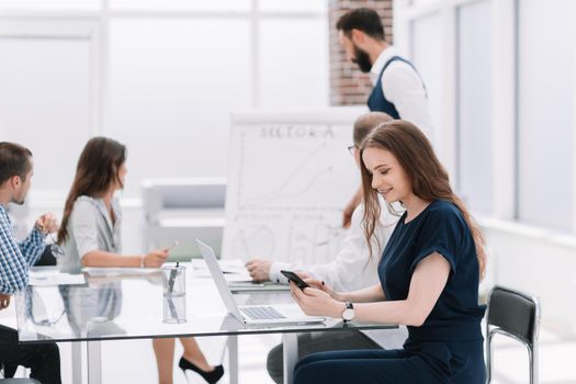 close up. businesswoman typing SMS on a smartphone . people and technology