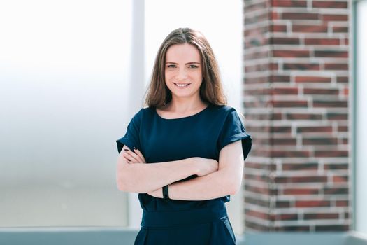 young business woman standing in office lobby.