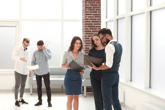 employees discussing business documents in the office lobby.photo with copy space