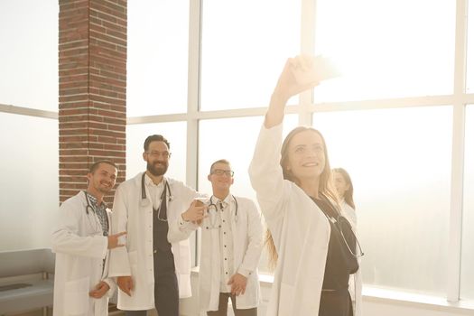 team of doctors at the medical center taking a selfie. people and technology