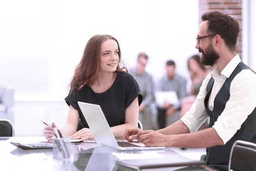 two employees sitting at a Desk in the office. business concept