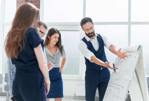 businessman standing near the flipchart in the conference room.business and education