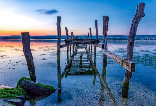 Old broken wooden pier in blue hour