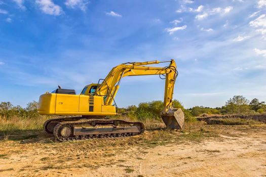 A stopping yellow excavator after work