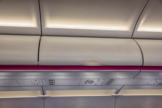 Luggage shelf in an airplane. Aircraft interior. Travel concept