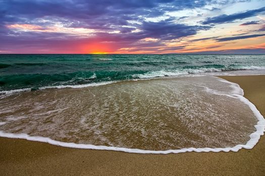 Beautiful sunrise over the sea. Wave pattern