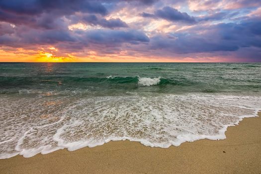Beautiful sunrise over the sea. Wave pattern