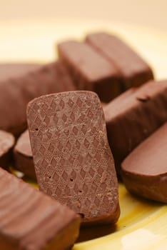 dark chocolate on a plate on table close up .