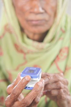 senior young women hand using pulse oximeter.