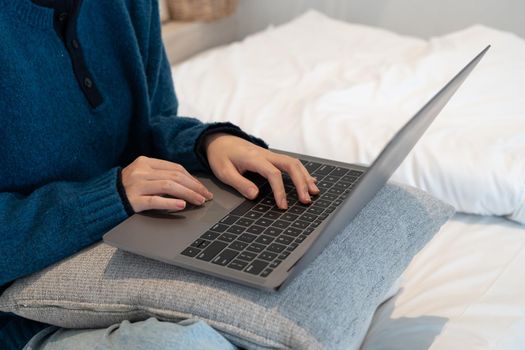 Close Up on Hands of a Female Specialist Working on Laptop Computer at Cozy Home Living Room while Sitting at a Table. Freelancer Woman Chatting Over the Internet on Social Networks