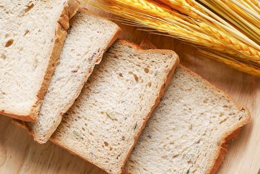 fresh bread with wheat ears on table ,