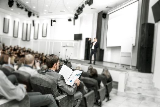 in the foreground: a businessman on a business conference. business training