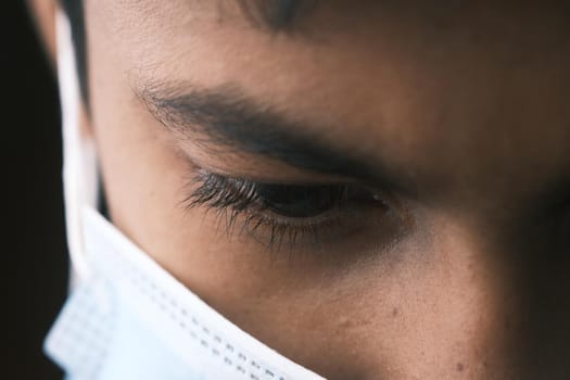 Close up of man with protective face mask looking at camera.